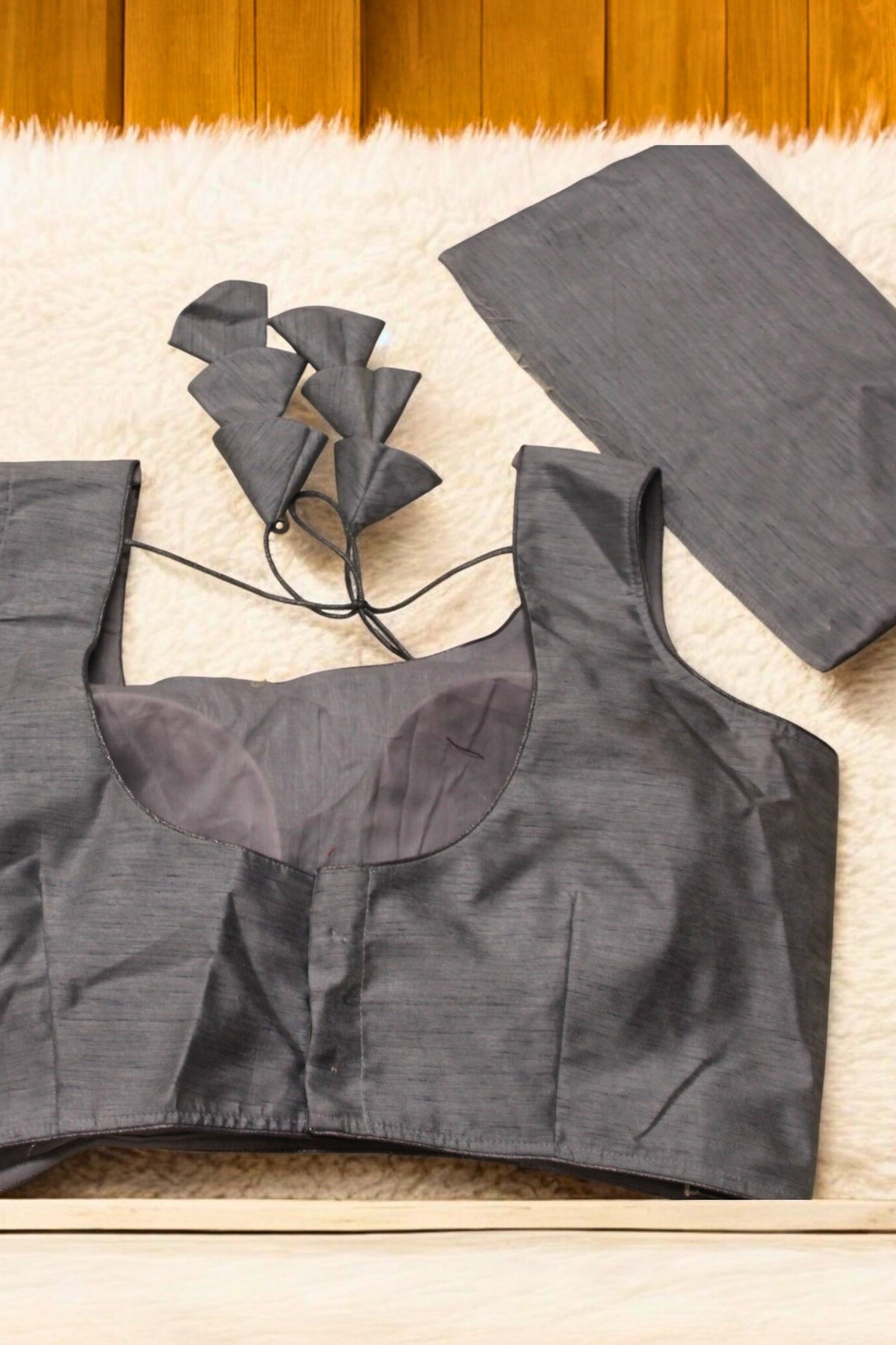 Gray crop top with sheer neckline on a wooden surface