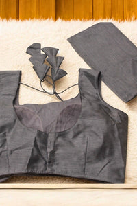 Gray crop top with sheer neckline on a wooden surface
