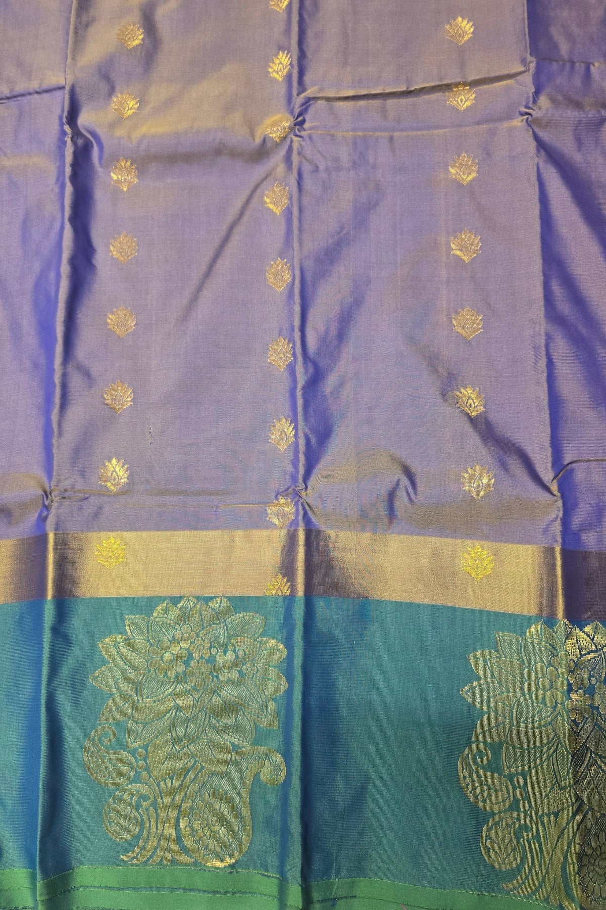 Blue and green traditional fabric with gold patterns