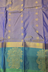 Blue and green traditional fabric with gold patterns