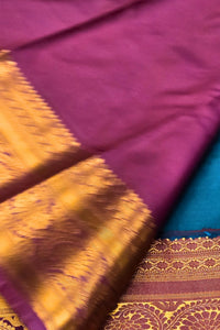 Close-up of a purple fabric with gold and blue patterns