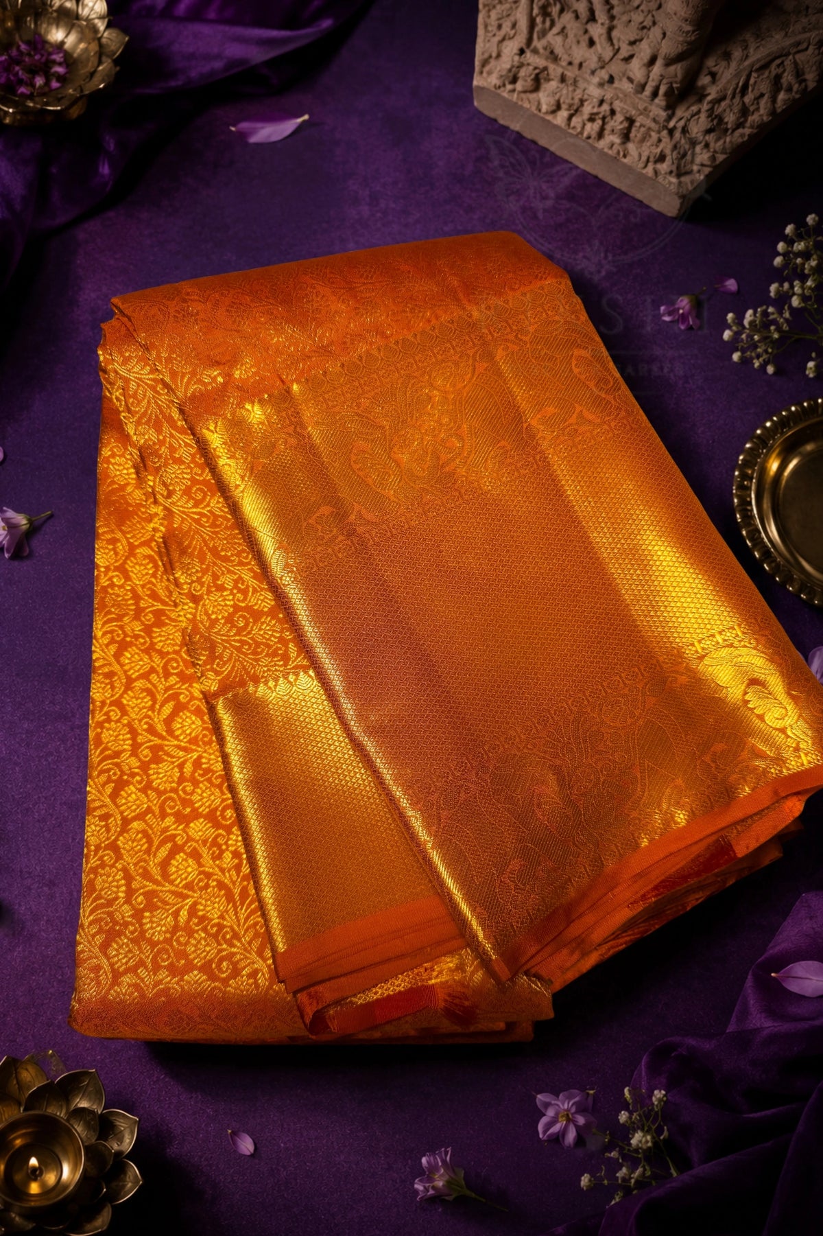 Orange Gold Floral Brocade Woven Fabric draped elegantly, showcasing its intricate patterns and rich shimmer.