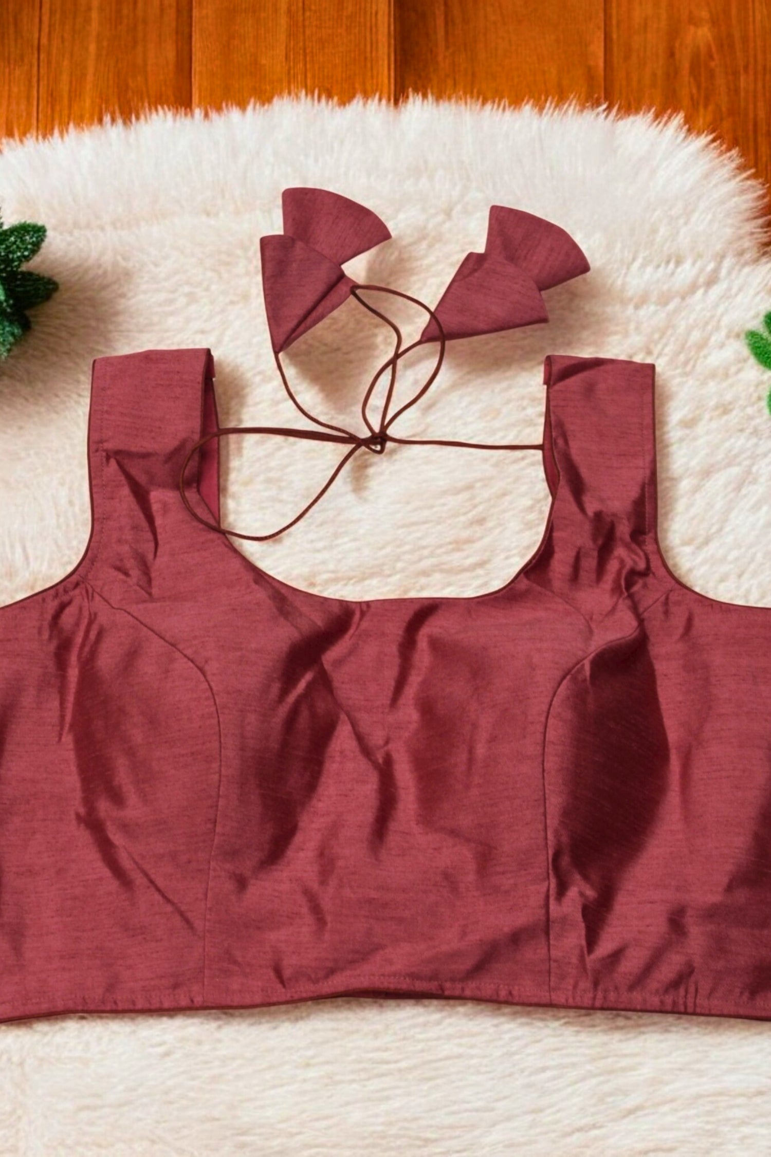 Red bikini top with matching bottoms on a white rug