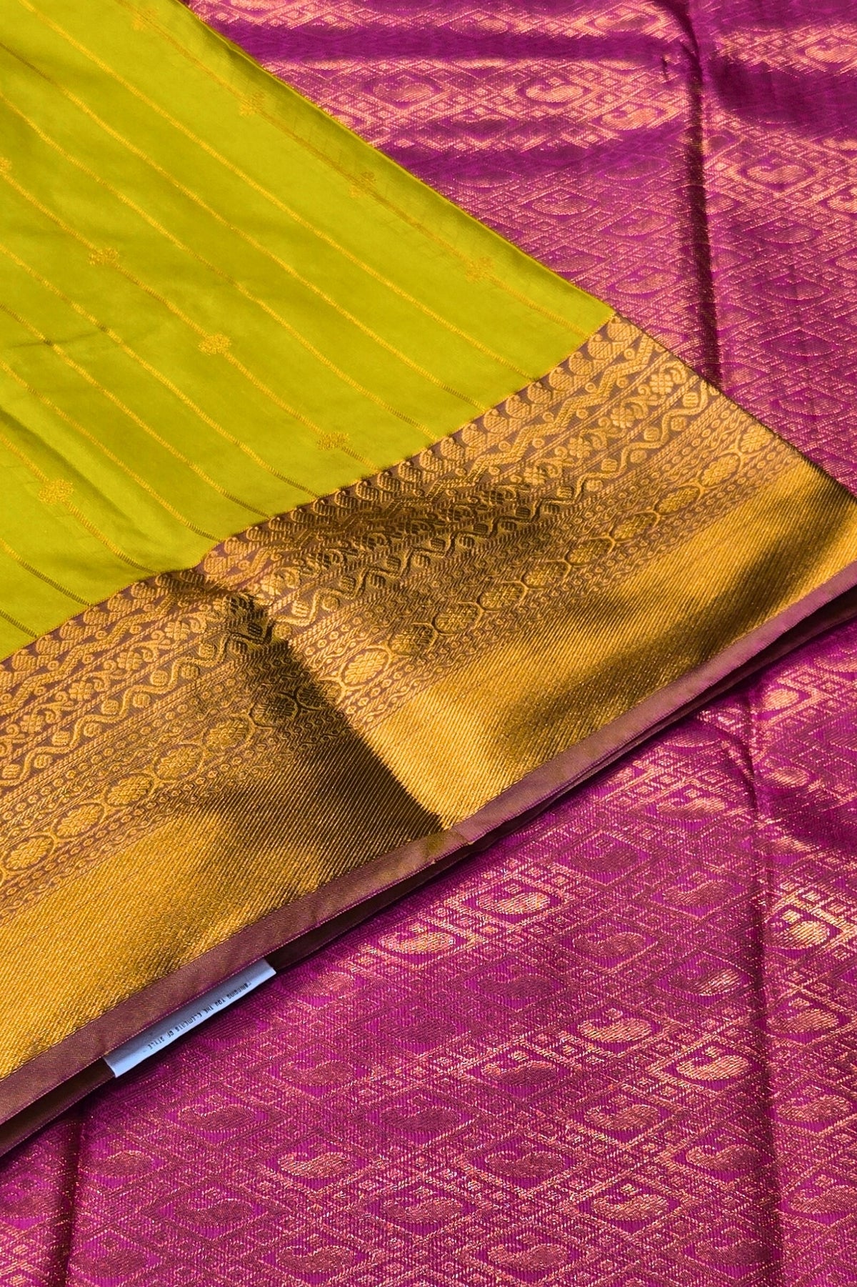 Close-up of a green and purple fabric with gold border