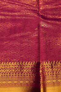 Close-up of maroon fabric with gold patterns