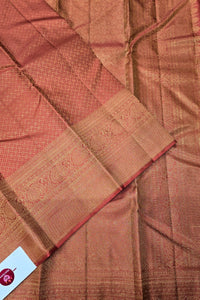 Close-up of brown fabric with intricate patterns and a label in the corner.