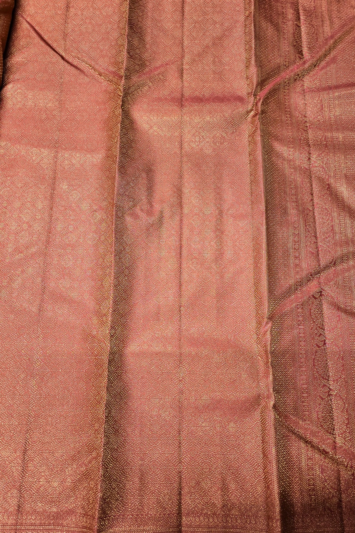 Close-up of a textured pink fabric with a subtle pattern