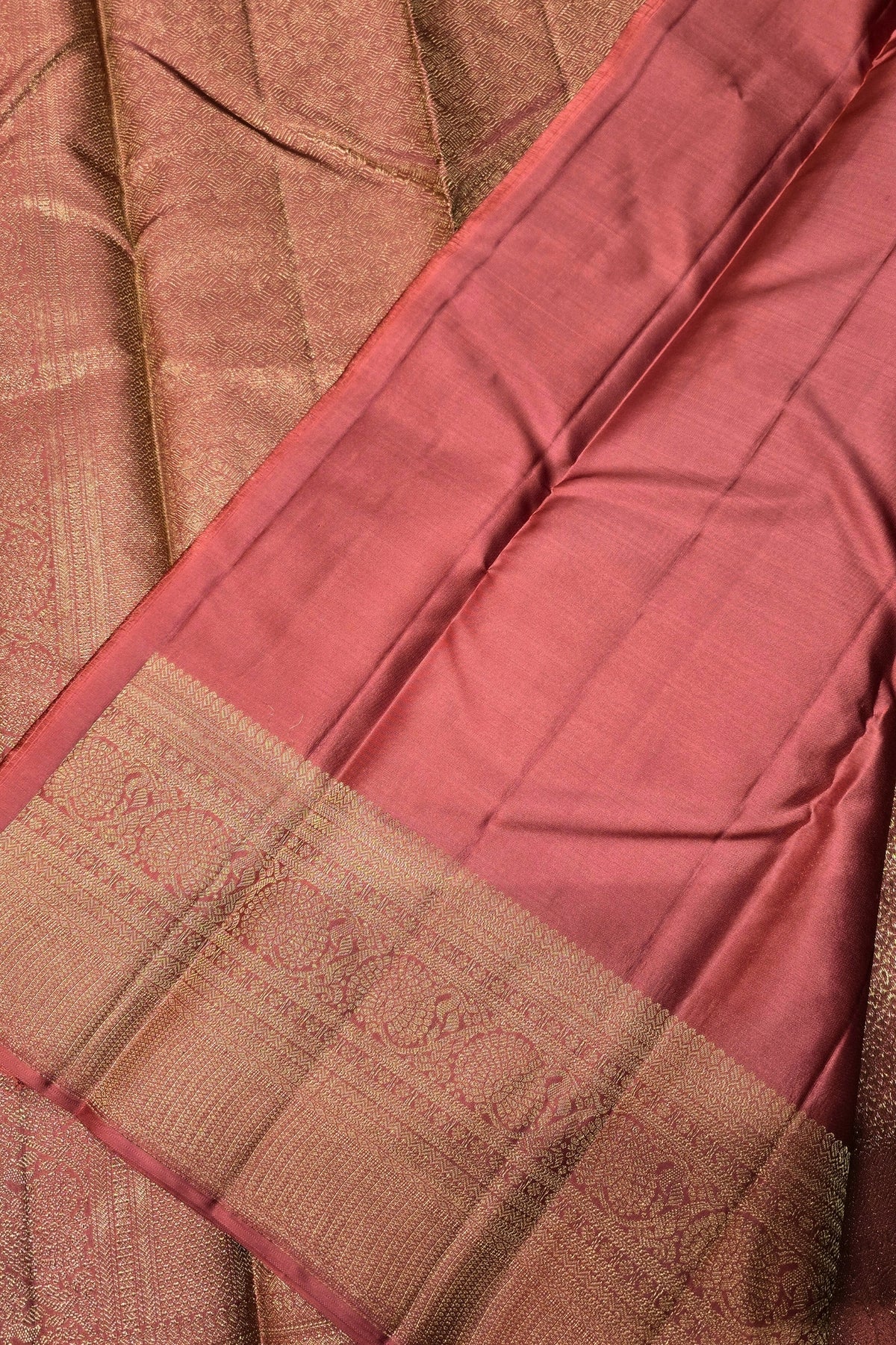 Close-up of a maroon saree with a brown border