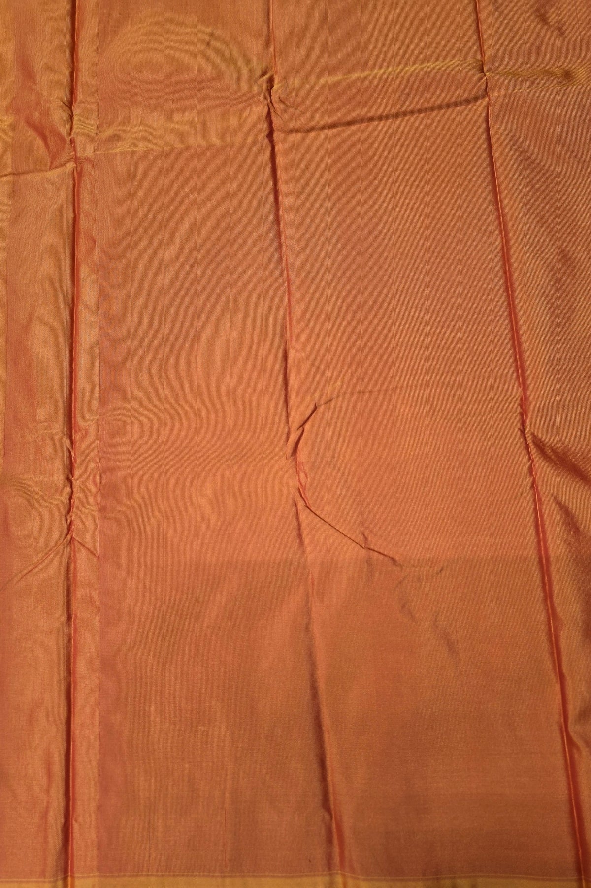 Close-up of orange fabric with visible texture