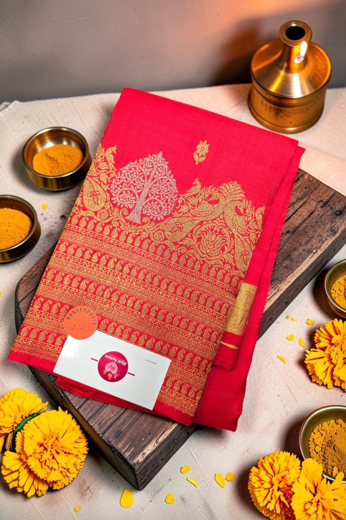 Red patterned towel on a wooden board with yellow flowers and small containers on a light background