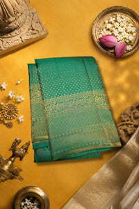 Sea Green Kanchipuram Silk Saree with Brocade Design displayed on a vibrant yellow surface.