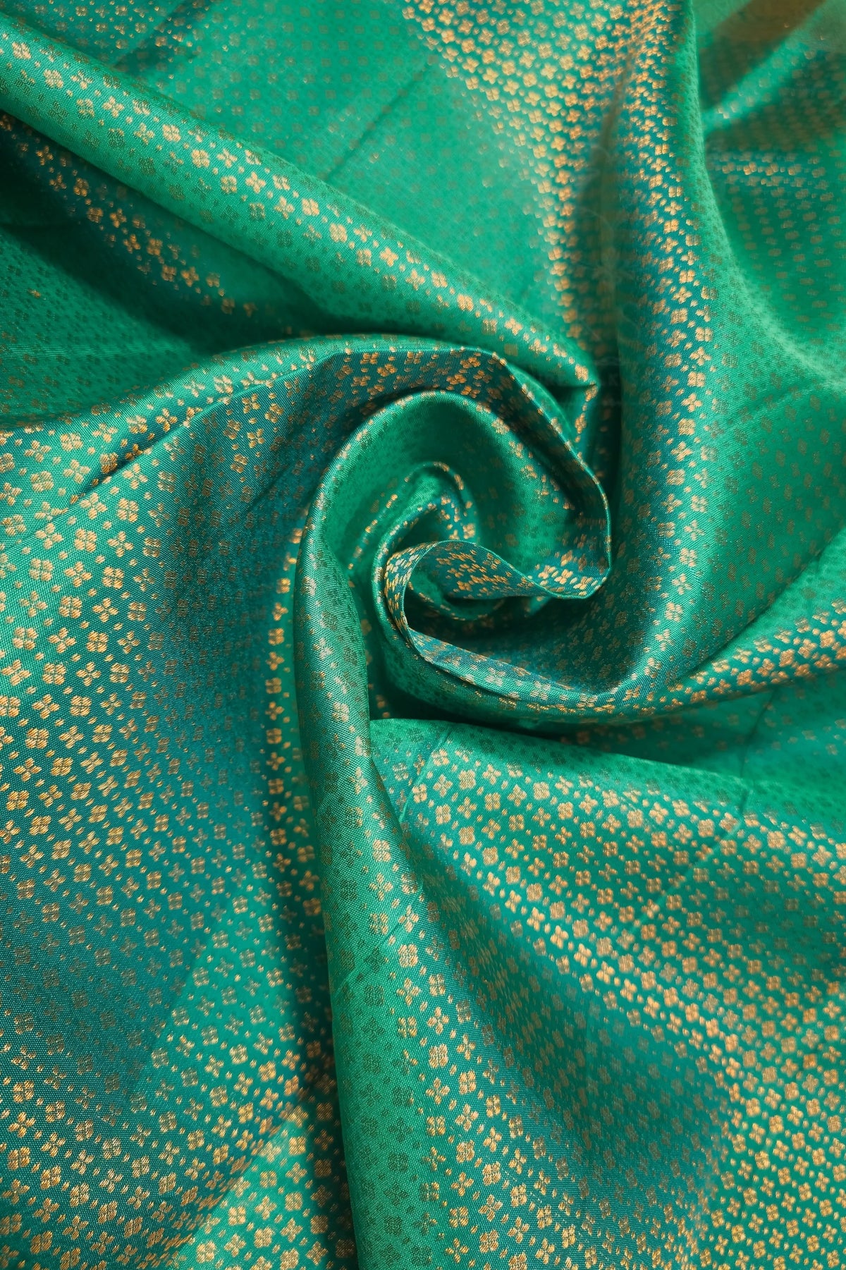 Sea Green Kanchipuram Silk Saree with Brocade Design featuring intricate golden patterns on rich sea green fabric.