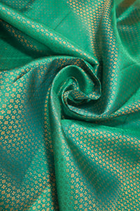 Sea Green Kanchipuram Silk Saree with Brocade Design featuring intricate golden patterns on rich sea green fabric.