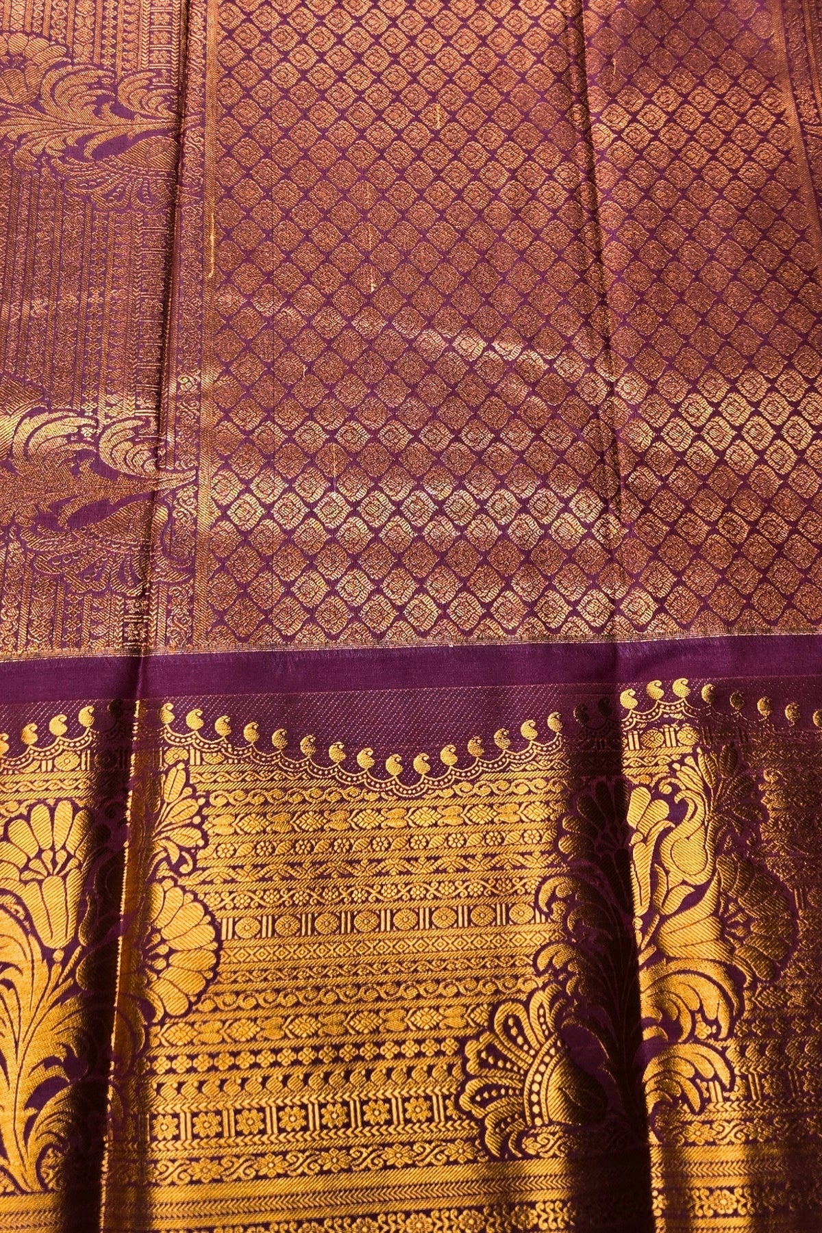 Brown and gold patterned fabric with intricate designs