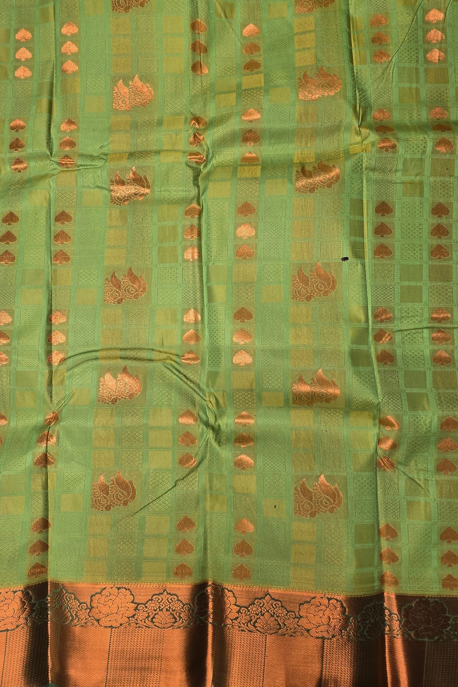 Green fabric with gold patterns and border