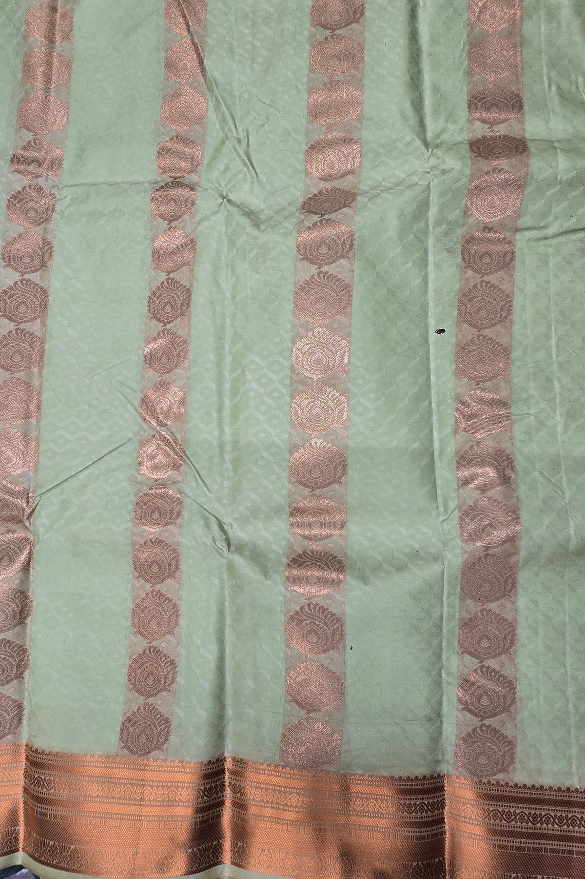 Light green fabric with brown decorative patterns