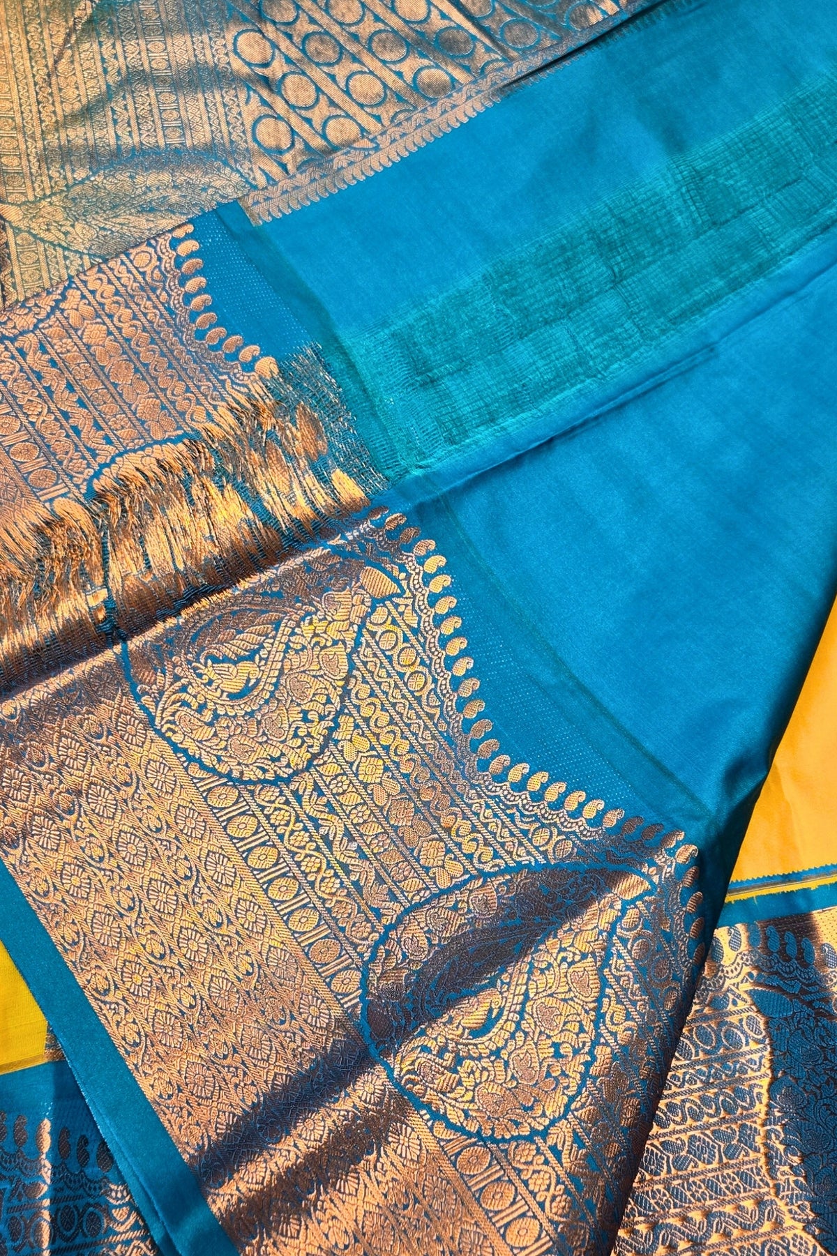 Blue and gold patterned fabric with a yellow border