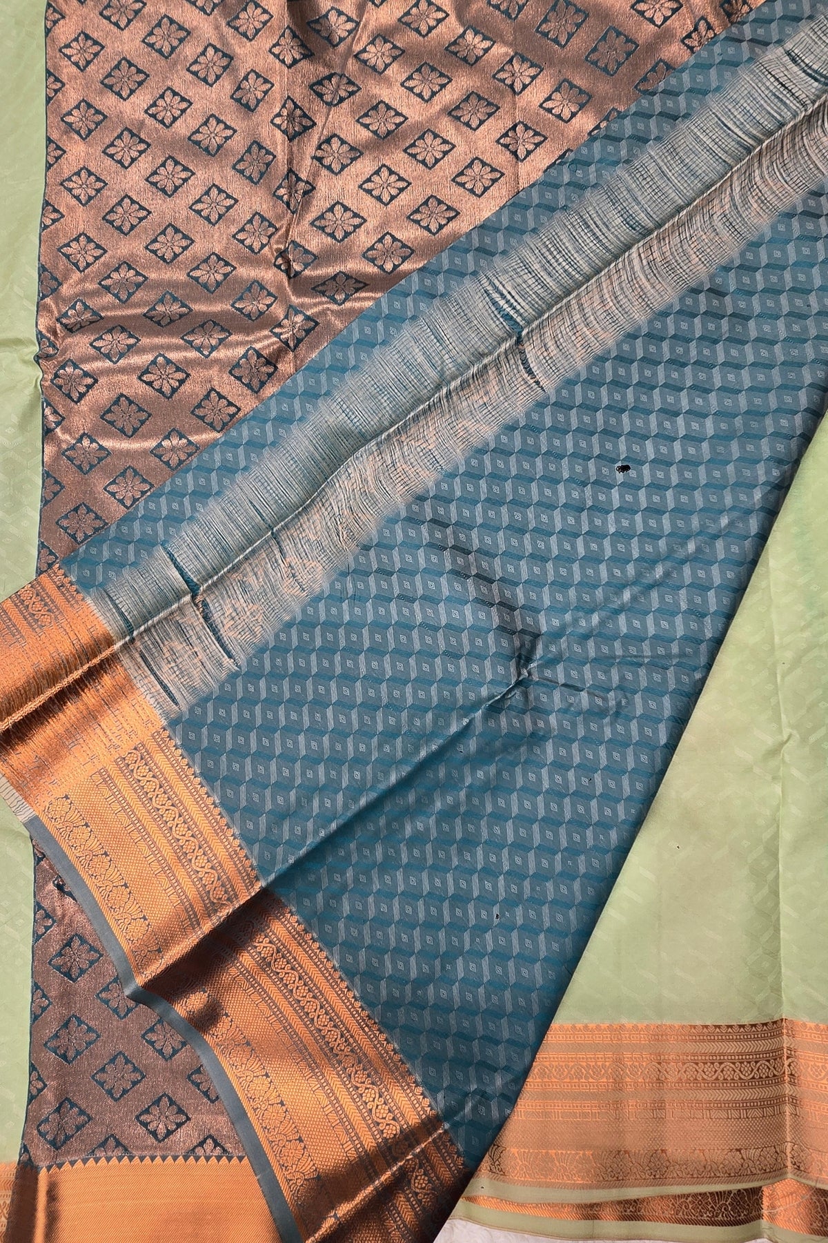 Close-up of a patterned fabric with blue, brown, and green colors.