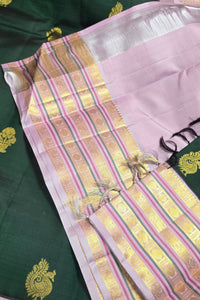 Traditional saree with pink and gold border on a green background