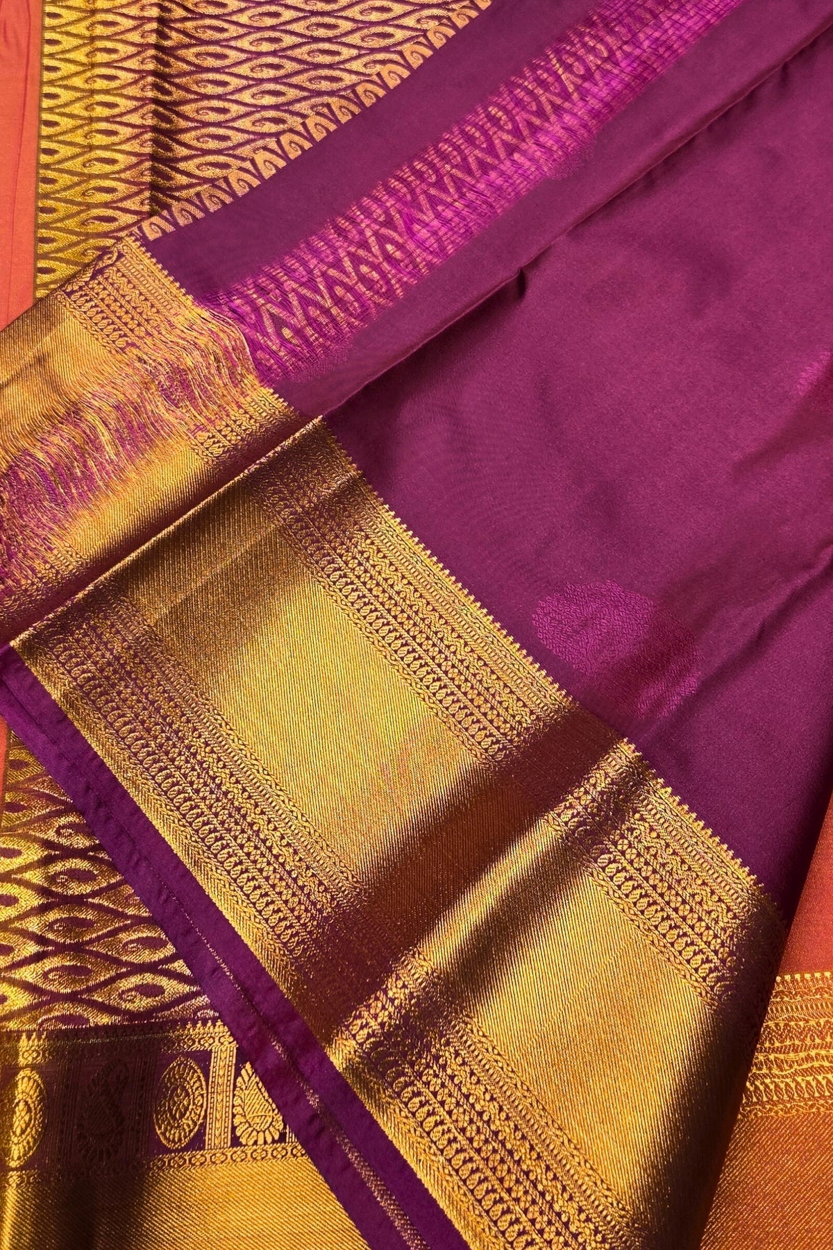 Purple and gold traditional fabric with intricate patterns