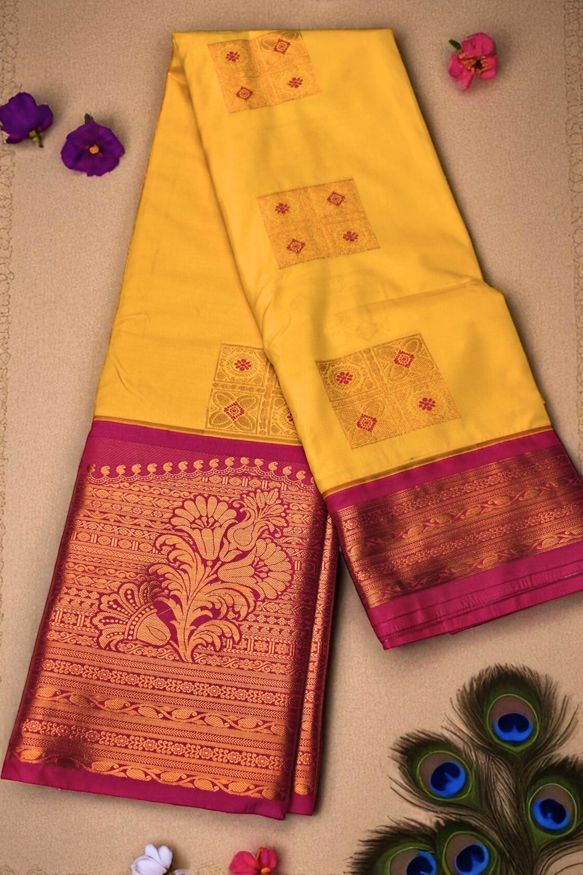 Yellow saree with pink and gold border on a beige background