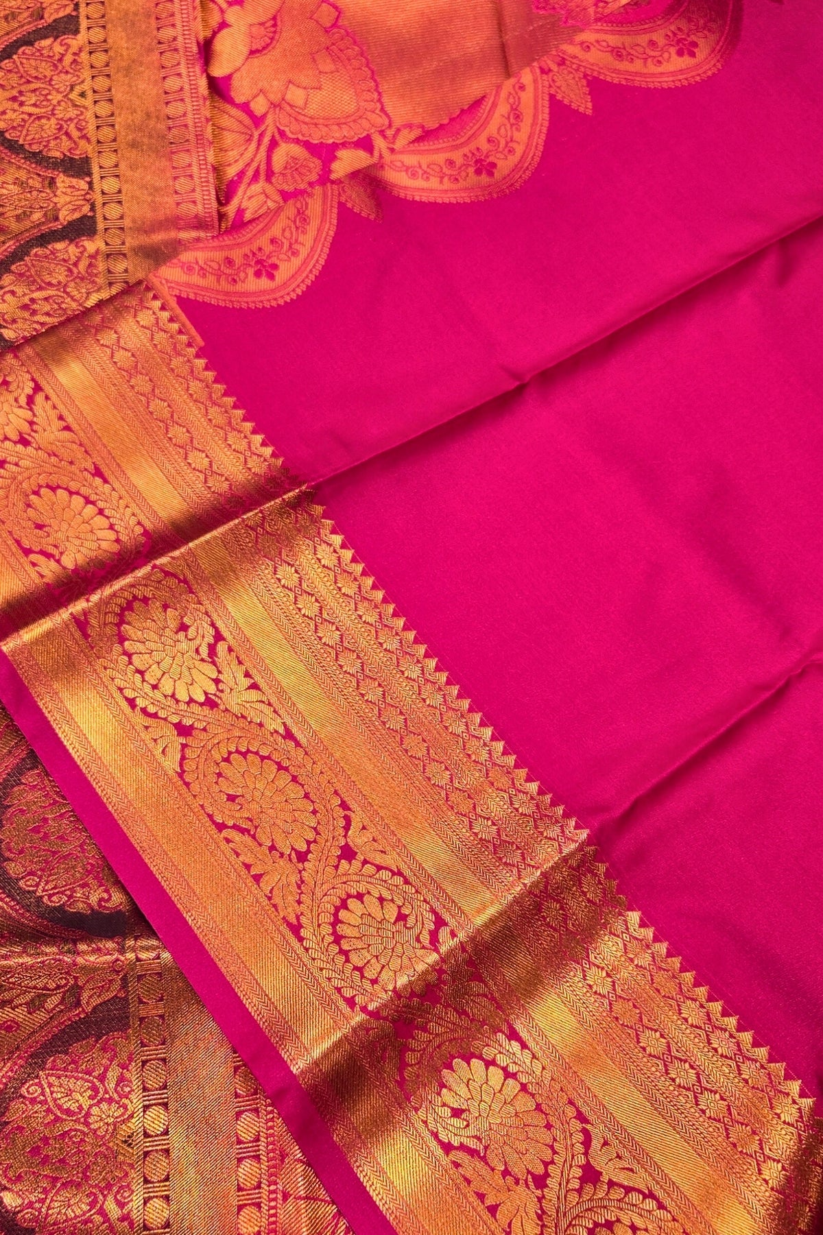 Pink saree with gold border and intricate patterns