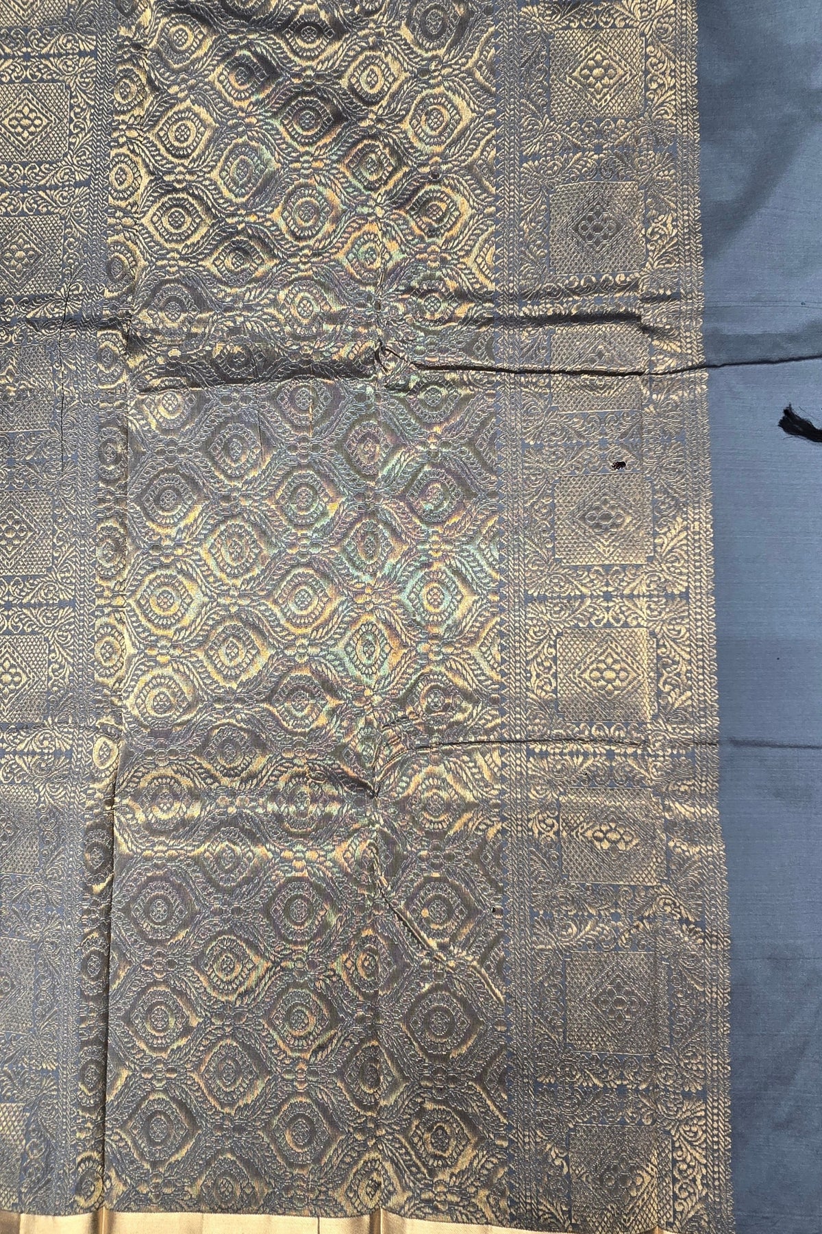 Textile with gold geometric pattern on a dark background