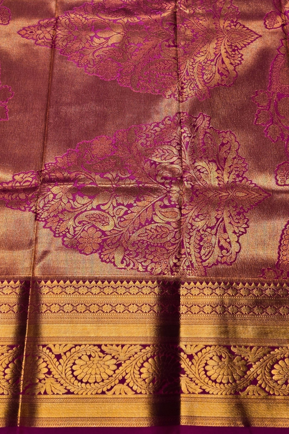 Close-up of a fabric with intricate purple and gold patterns