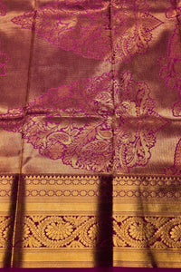 Close-up of a fabric with intricate purple and gold patterns