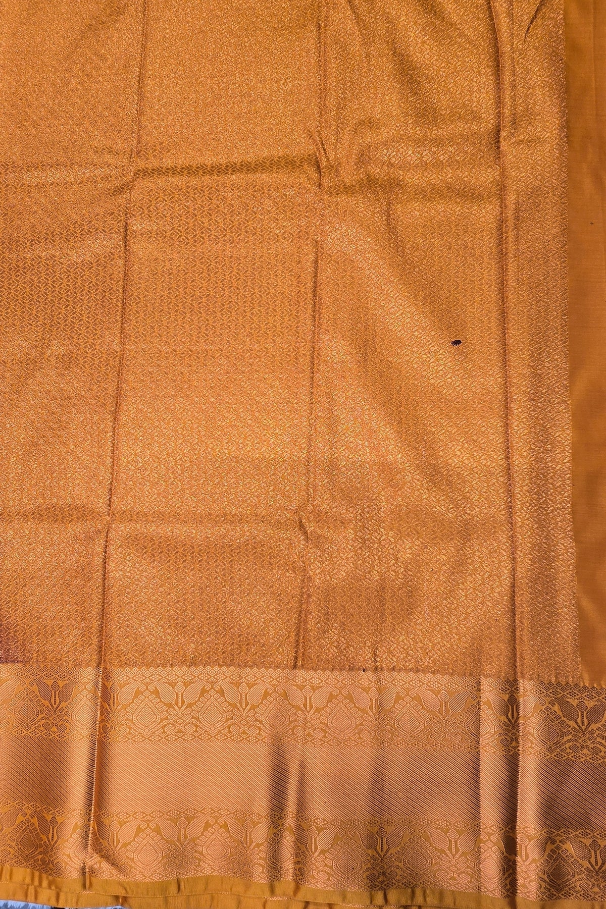 Close-up of a brown fabric with a subtle pattern