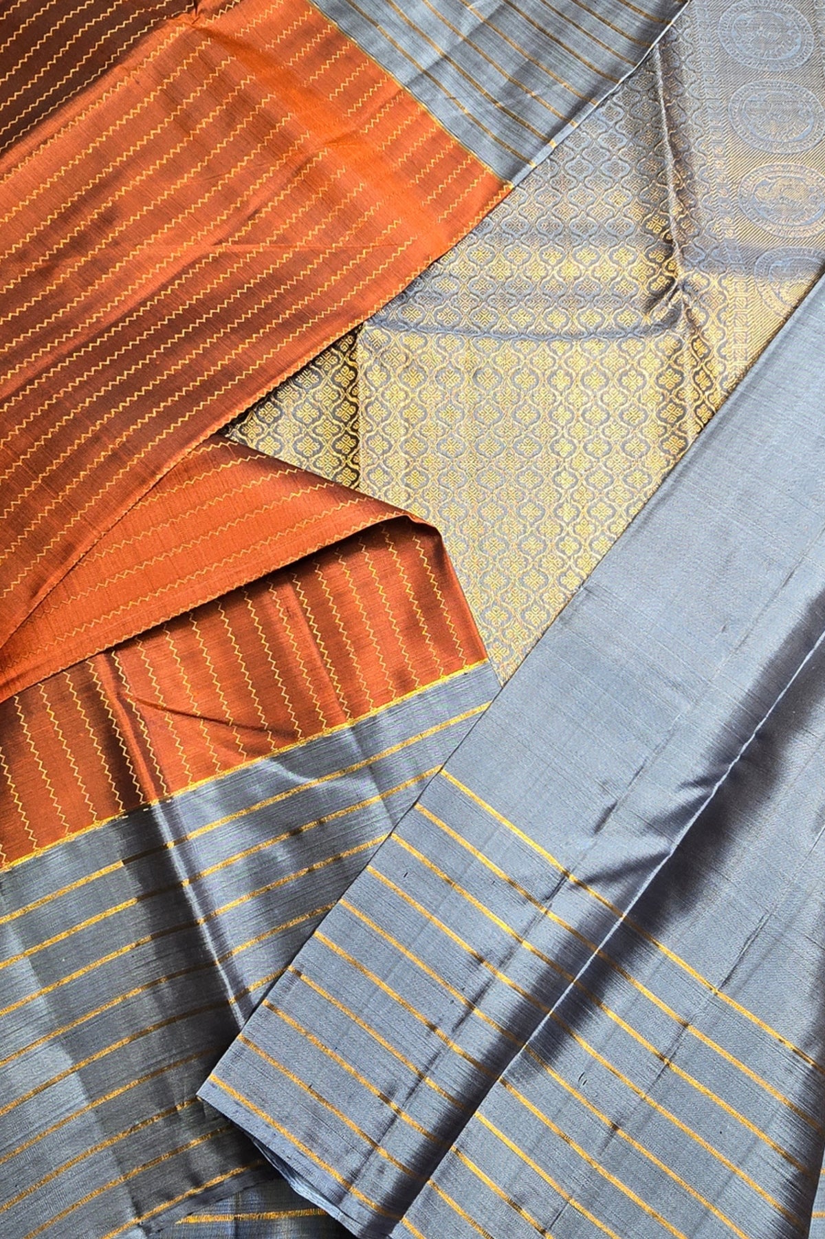 Close-up of fabric with orange, gray, and gold patterns