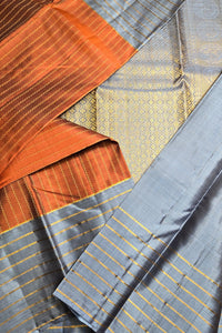 Close-up of fabric with orange, gray, and gold patterns