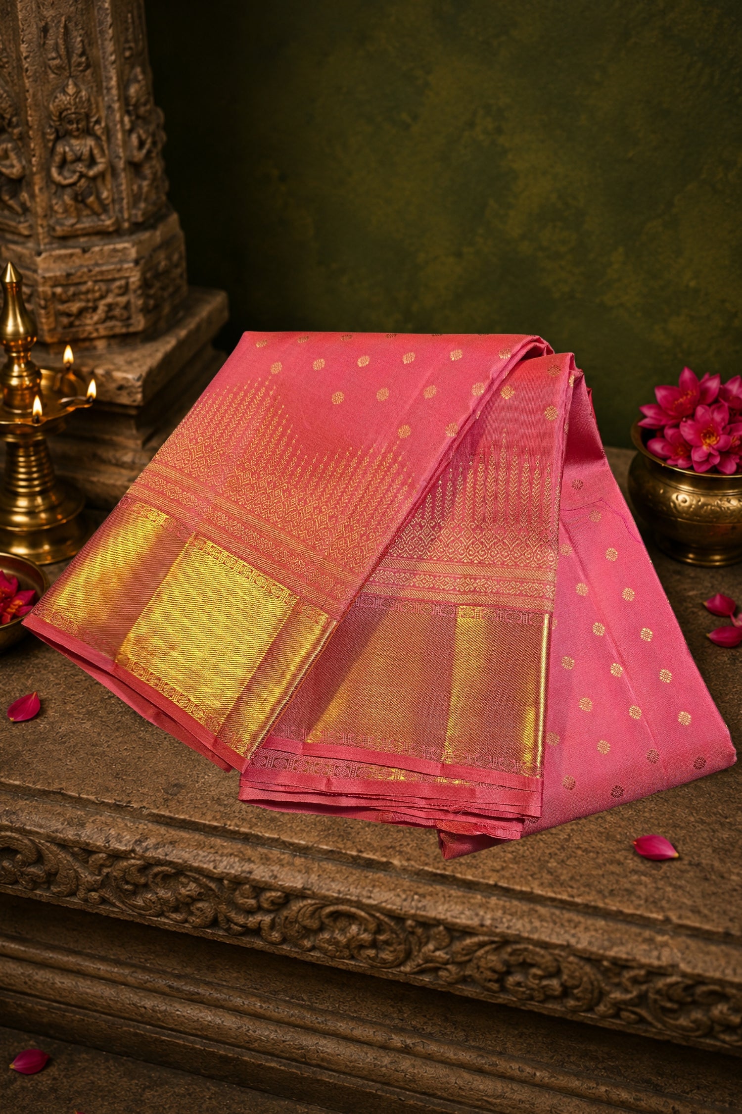 Peach pink silk saree with gold zari, showcasing intricate gold patterns and a wide gold border.