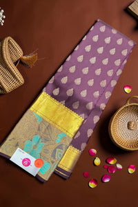 Purple fabric with gold patterns on a brown surface with decorative elements