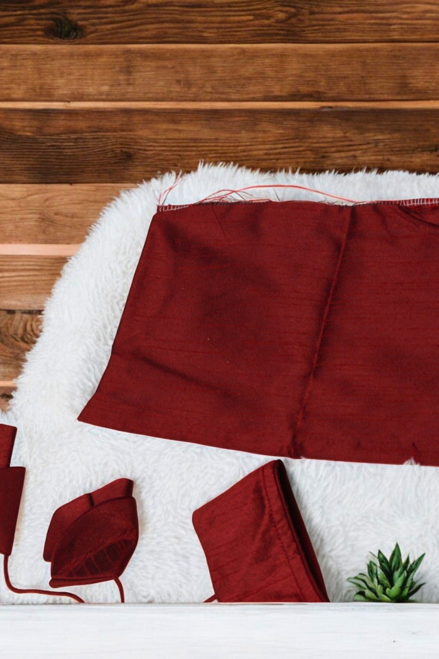 Red fabric on a white surface with a wooden background