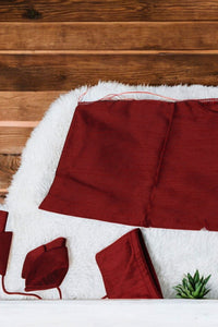 Red fabric on a white surface with a wooden background