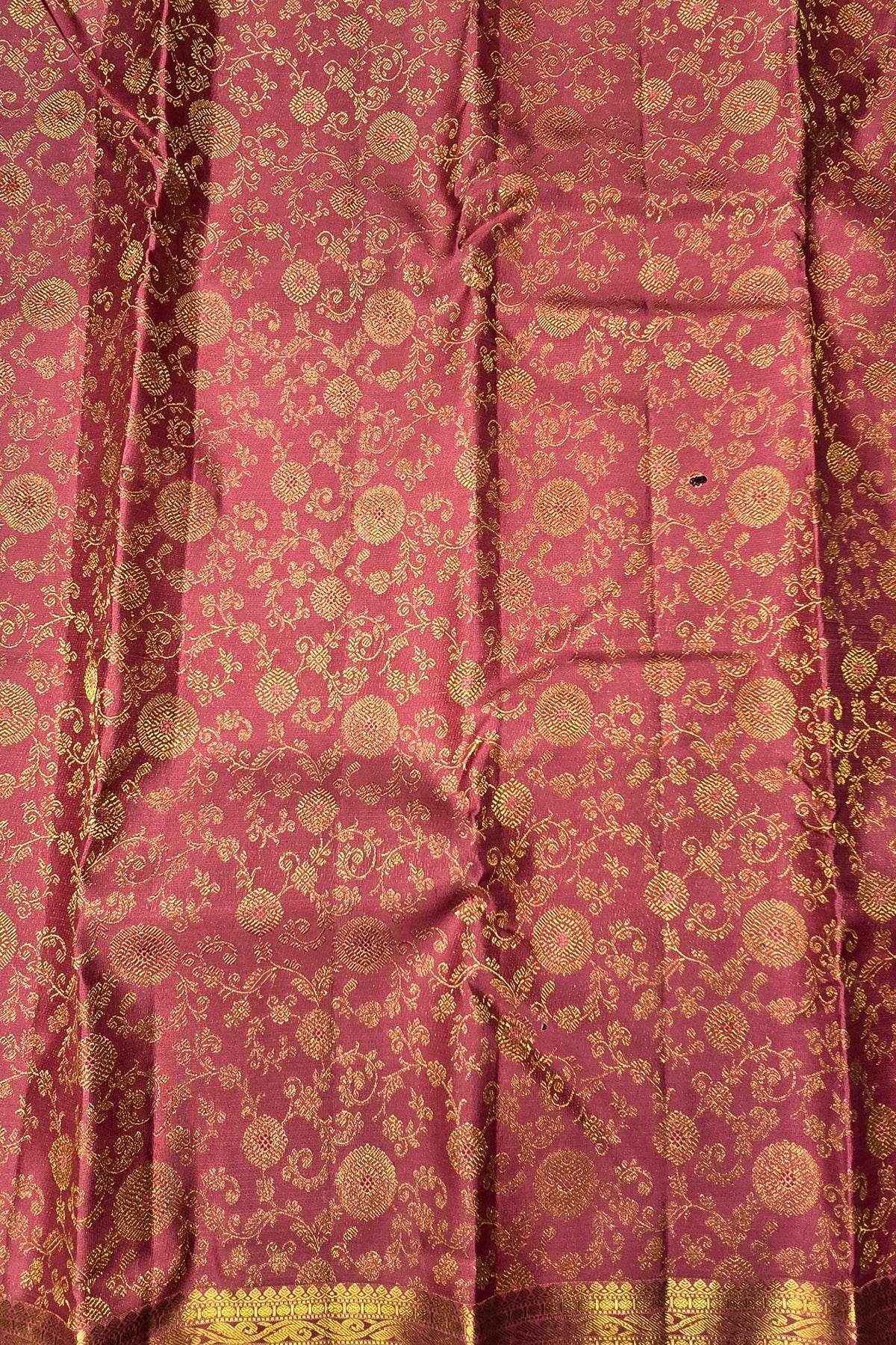 Pink fabric with gold intricate patterns