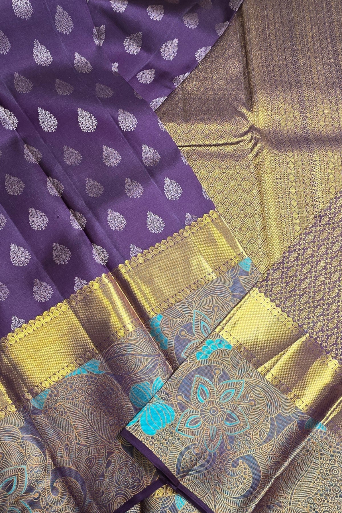 Purple fabric with white patterns and gold border, alongside a textured brown fabric.