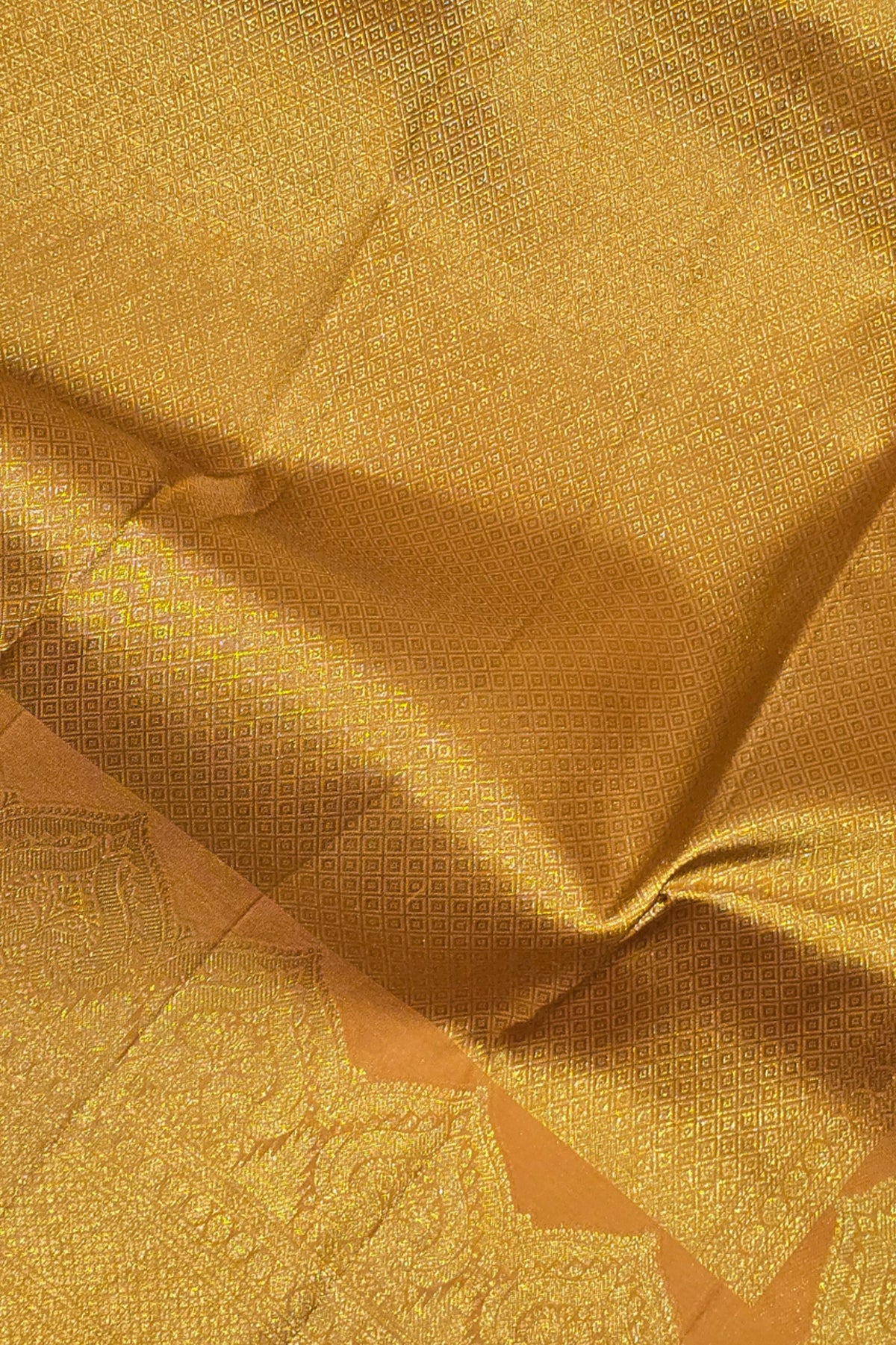 Close-up of gold fabric with intricate patterns