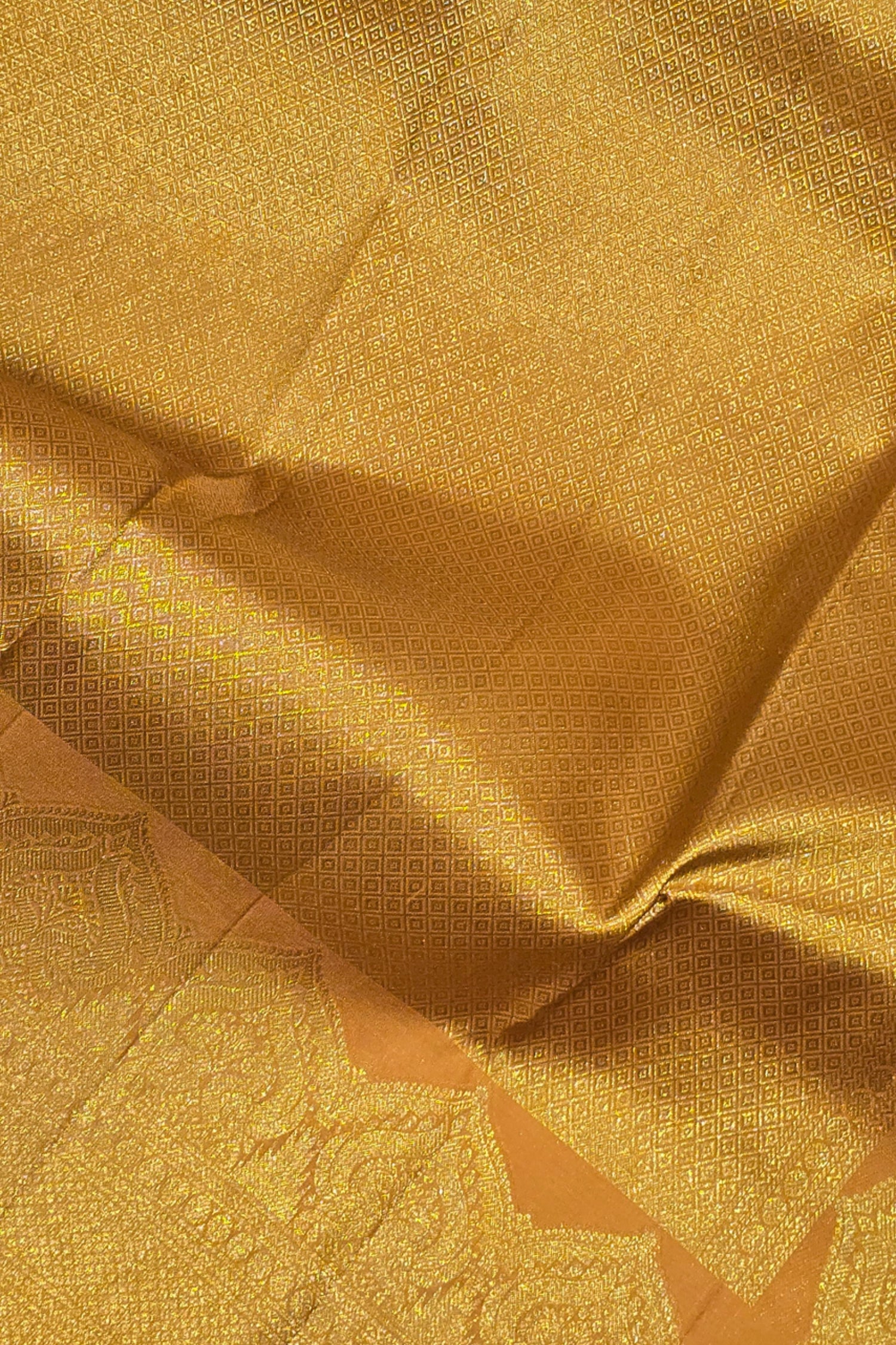 Close-up of gold fabric with intricate patterns