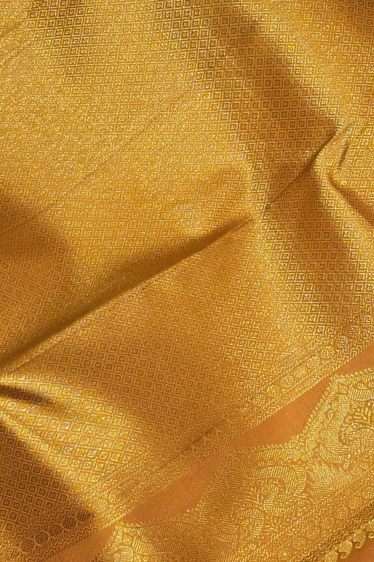 Close-up of gold fabric with intricate patterns