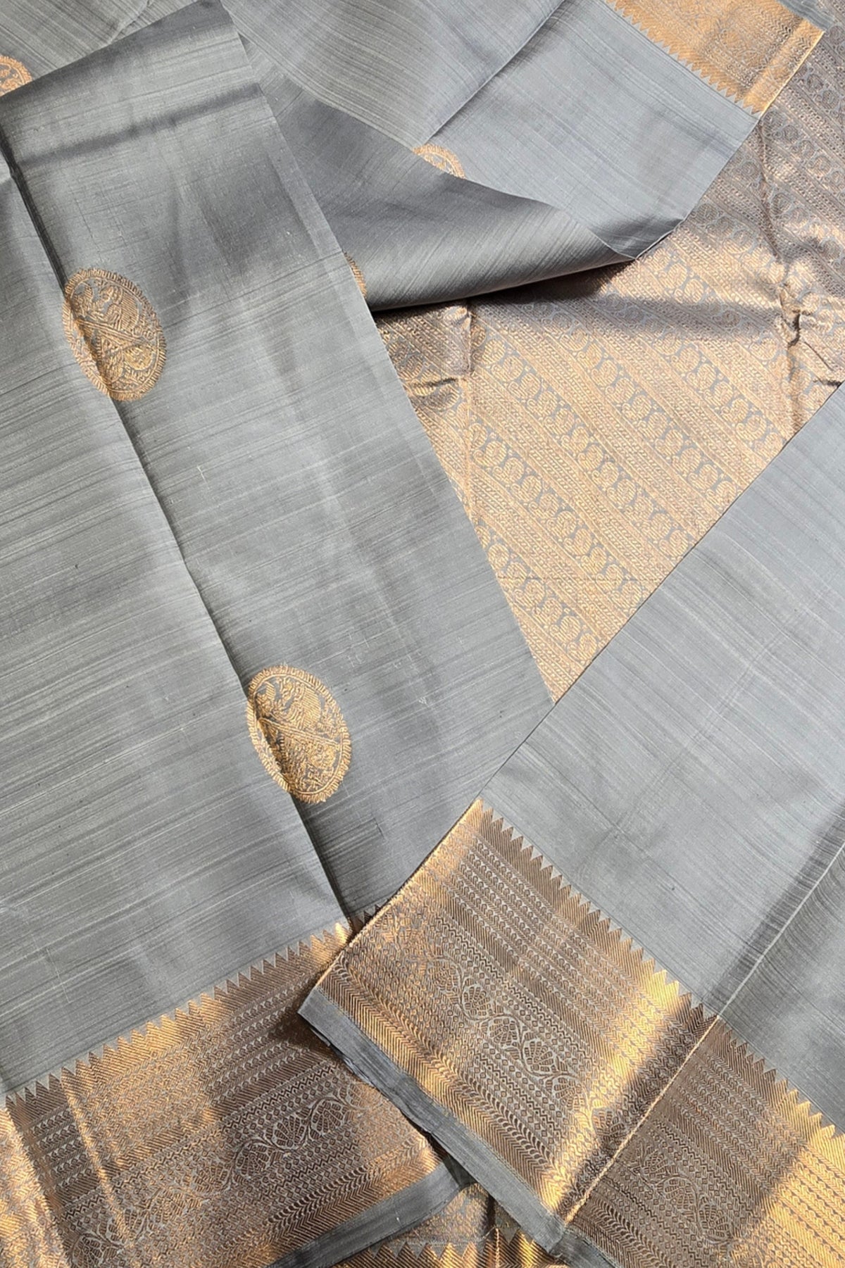 Gray fabric with gold accents and patterns