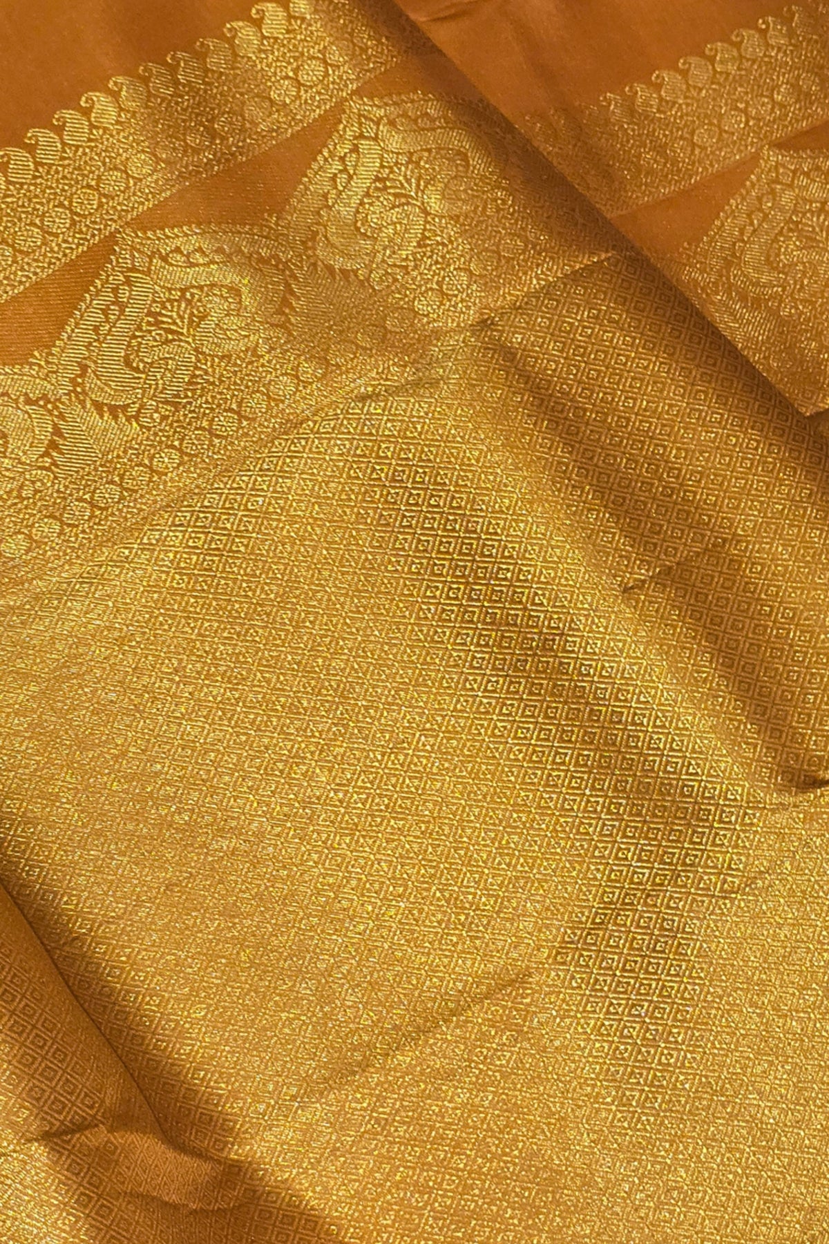 Close-up of gold fabric with intricate patterns