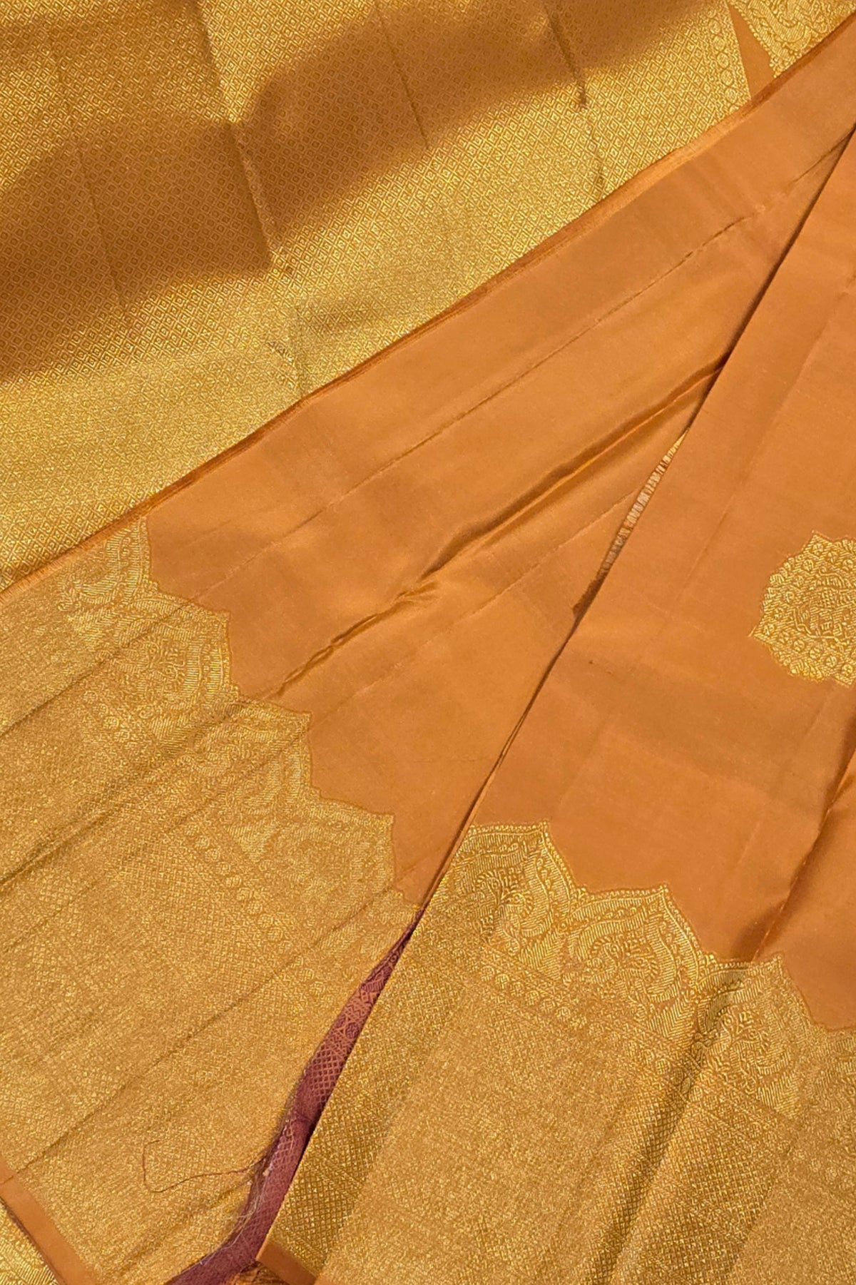 Close-up of gold and brown fabric with intricate patterns