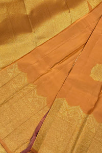 Close-up of gold and brown fabric with intricate patterns