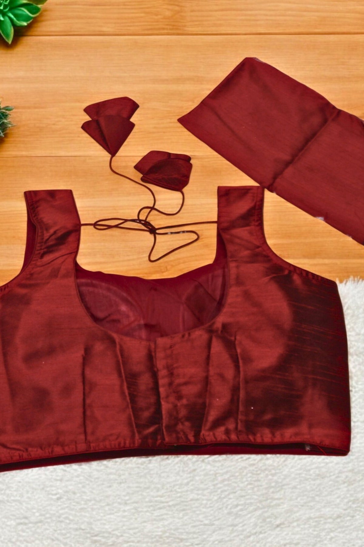 Red satin top on a wooden surface