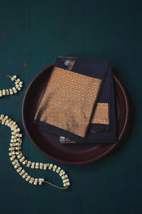 Folded fabric with intricate patterns on a dark green background