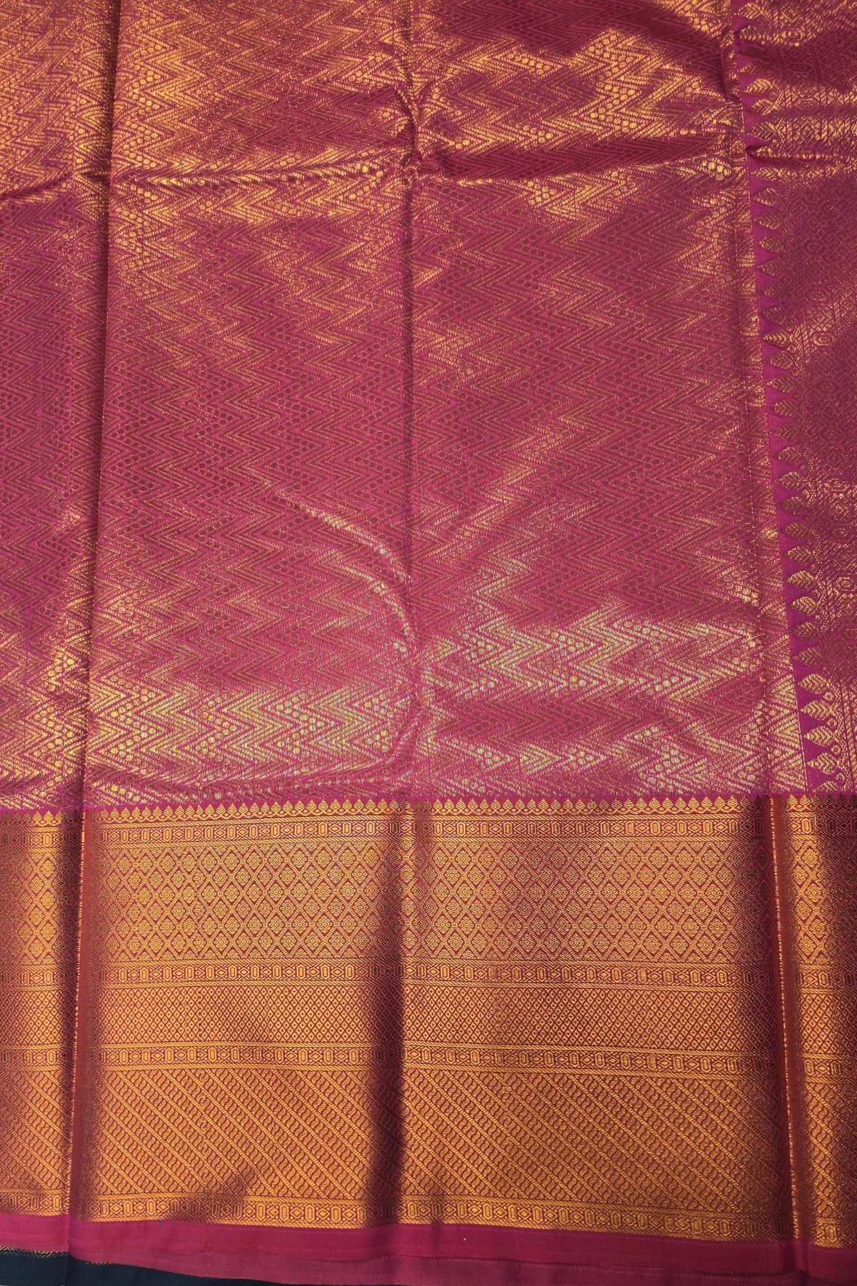 Traditional fabric with a pink and gold pattern