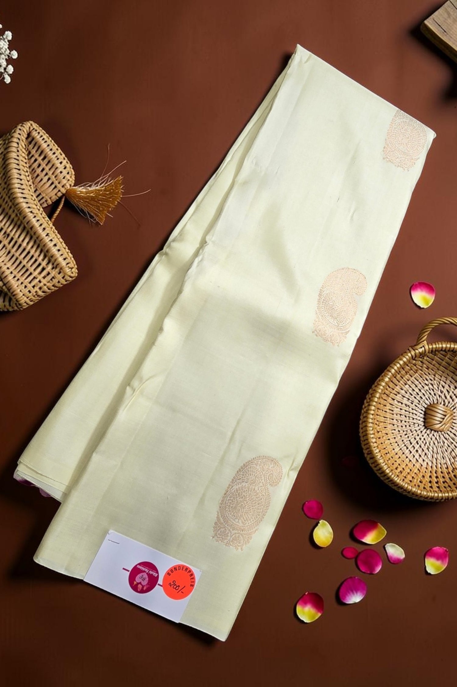 Light-colored fabric with a pattern on a brown surface with decorative elements.