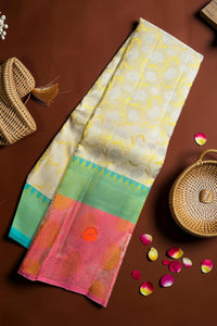 Colorful saree with floral patterns on a brown surface with baskets and petals.